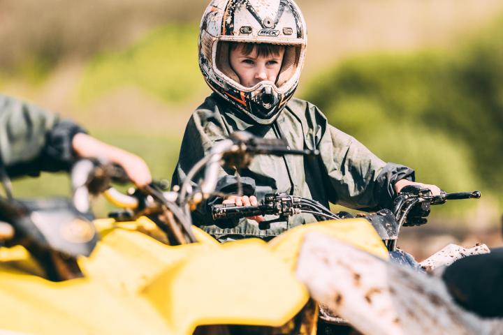 a person riding a motorcycle down a dirt road
