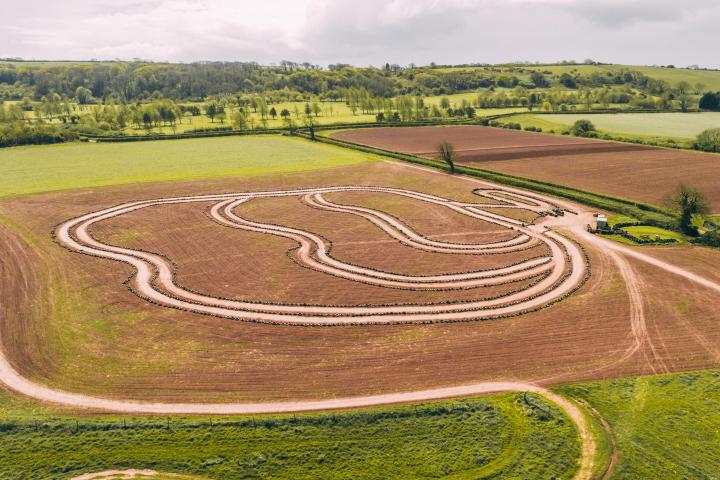 a train traveling down tracks near a field