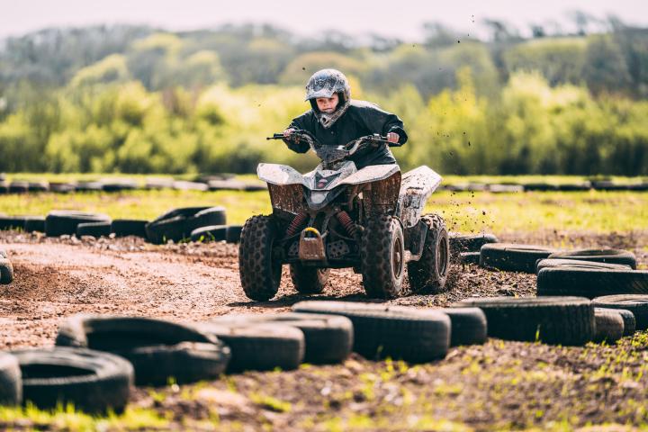 a man riding a bike down a dirt road