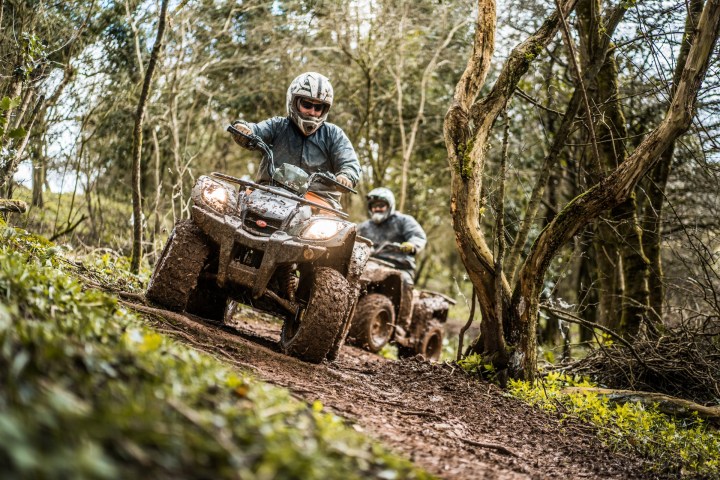 a man riding a bike down a dirt road