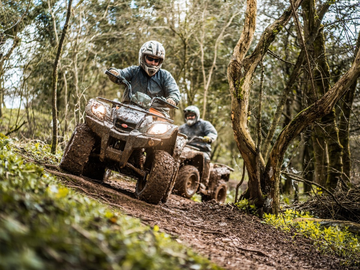 a man riding a bike down a dirt road